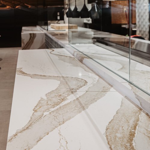 cambria-brittanicca-gold-delta-sky-lounge-37-progranite-countertop-natural-stone-designer-elegant-waterfall