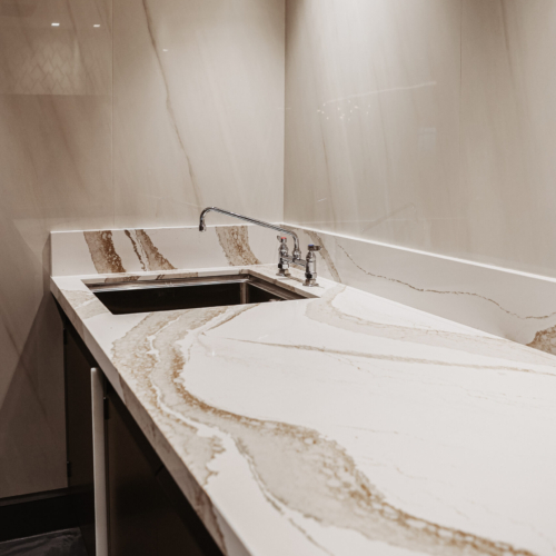 cambria-brittanicca-gold-delta-sky-lounge-63-natural-stone-seattle-public-private-restroom